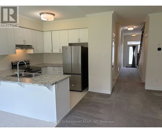 A kitchen with white cabinets and a granite countertop.