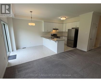 A spacious kitchen area with white cabinets and a central island.