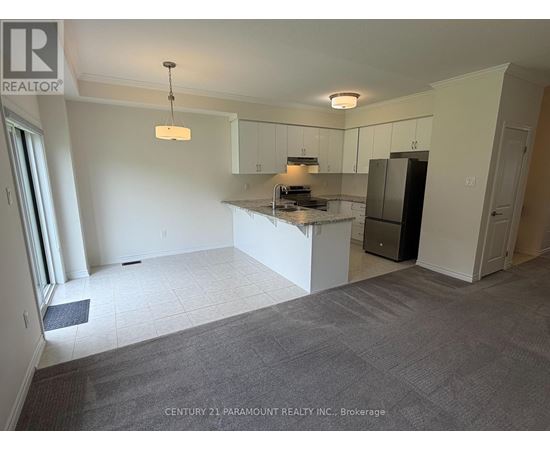 A spacious kitchen area with white cabinets and a central island.