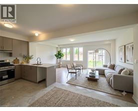 A well-lit, modern kitchen and living room with a dining area.