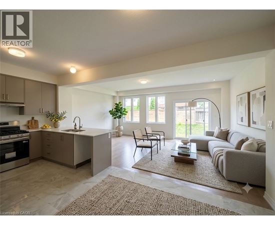 A well-lit, modern kitchen and living room with a dining area.