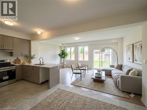 A well-lit, modern kitchen and living room with a dining area.