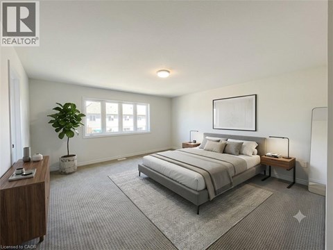 A well-lit bedroom with a large bed and a potted plant.