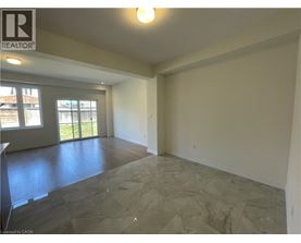 A spacious room with a slanted ceiling and a large window.