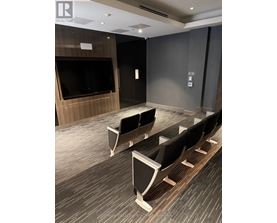 A conference room with a long table and chairs.