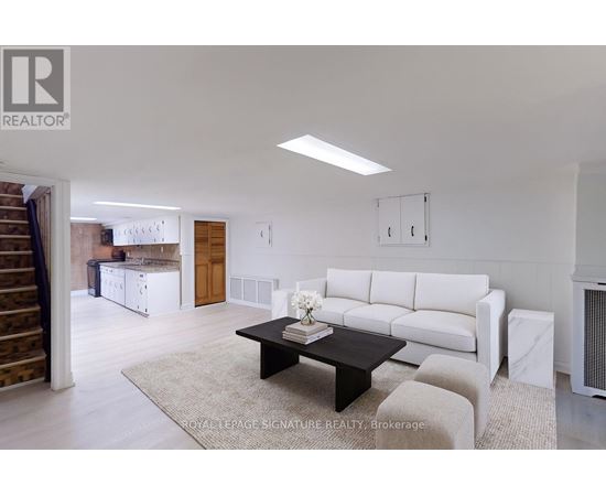 A living room with a white couch and a coffee table.