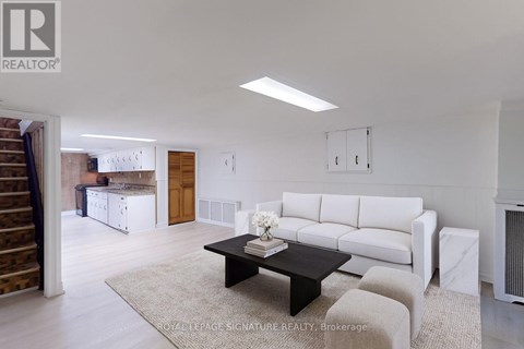 A living room with a white couch and a coffee table.