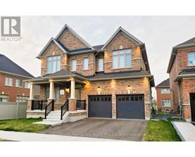 A large, two-story house with a brick facade and a garage is for sale.