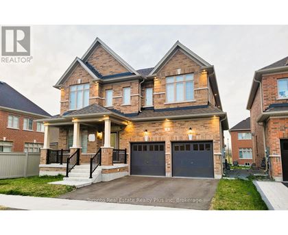 A large, two-story house with a brick facade and a garage is for sale.