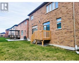 A brick building with a wooden deck in front.