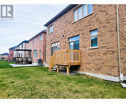 A brick building with a wooden deck in front.