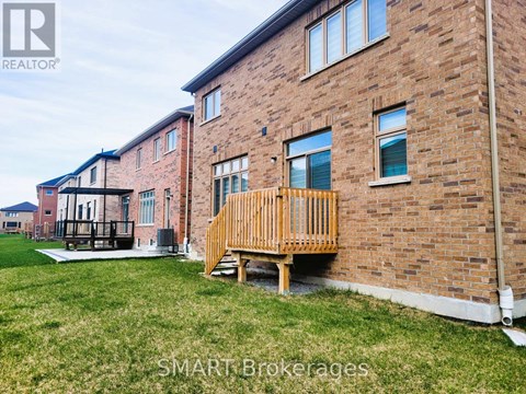 A brick building with a wooden deck in front.
