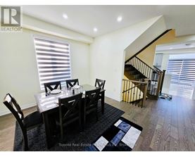 A dining room with a table set for four.