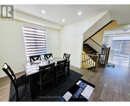A dining room with a table set for four.