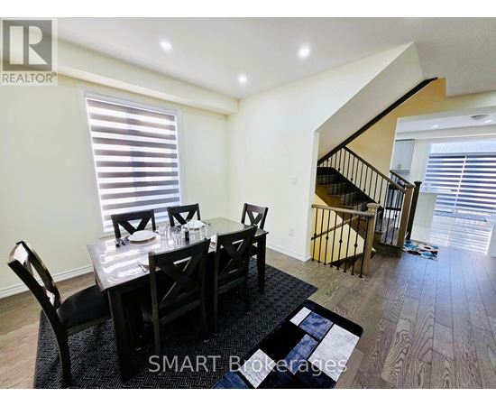 A dining room with a table set for four.