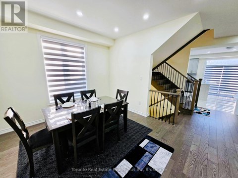 A dining room with a table set for four.