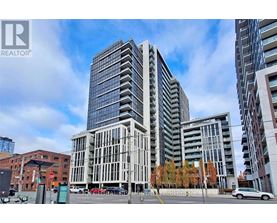 A modern glass building stands tall in an urban setting.