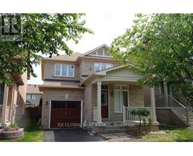A house with a garage and a driveway is for sale.