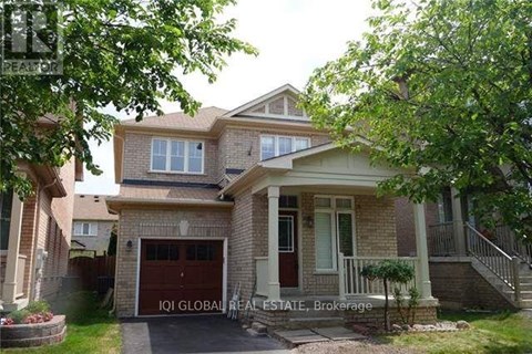 A house with a garage and a driveway is for sale.