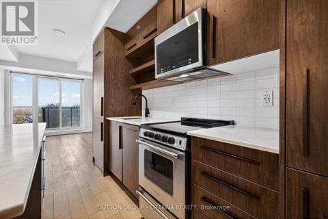 A modern kitchen with wooden cabinets and stainless steel appliances.