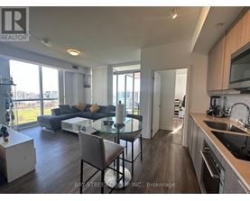 A modern kitchen with a dining table and chairs.