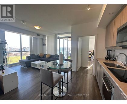 A modern kitchen with a dining table and chairs.