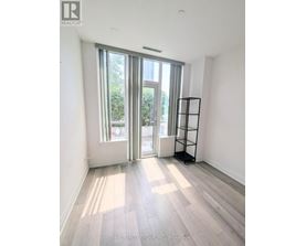 A room with a large window and a wooden floor.