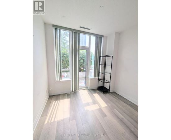 A room with a large window and a wooden floor.