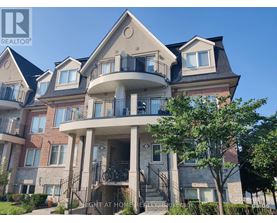 A large, multi-level residential building with balconies and a front porch.