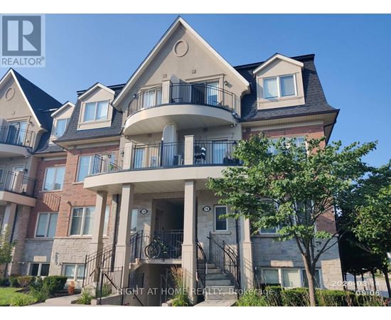 A large, multi-level residential building with balconies and a front porch.