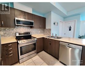 A kitchen with a stove, oven, and sink.