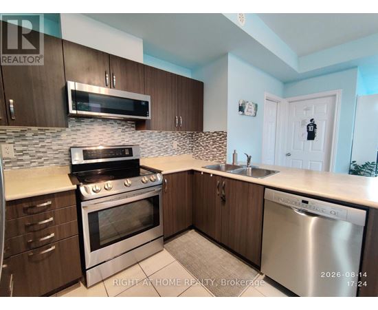 A kitchen with a stove, oven, and sink.