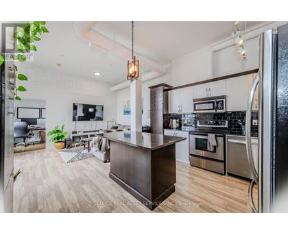 A modern kitchen with a wooden island in the middle.