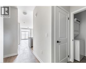A white room with a door and a washing machine in it.