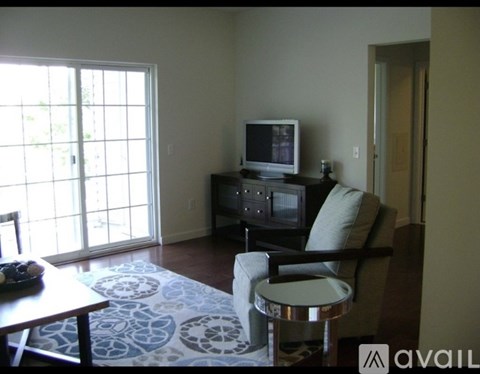 A living room with a television and a chair.