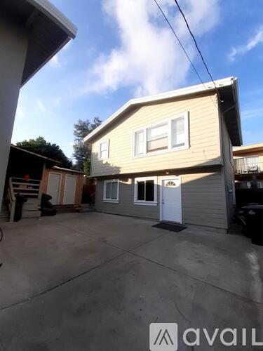 A house with a garage and a driveway in front of it.