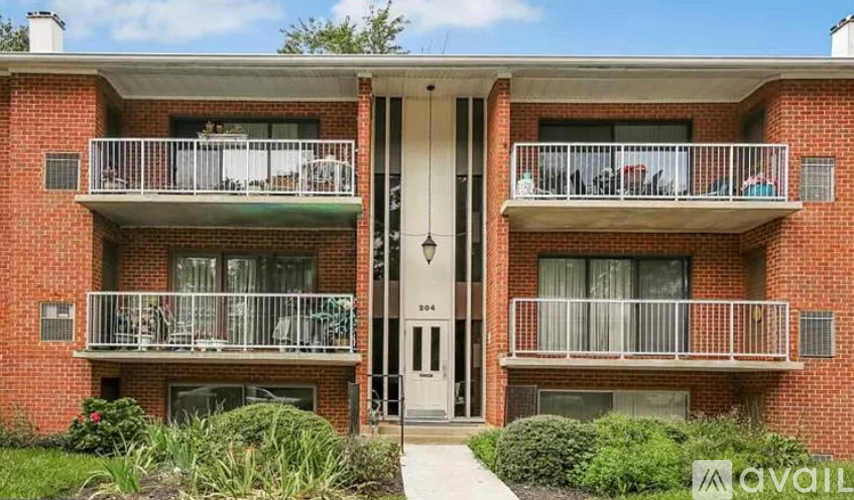 A red brick building with a balcony and a door.