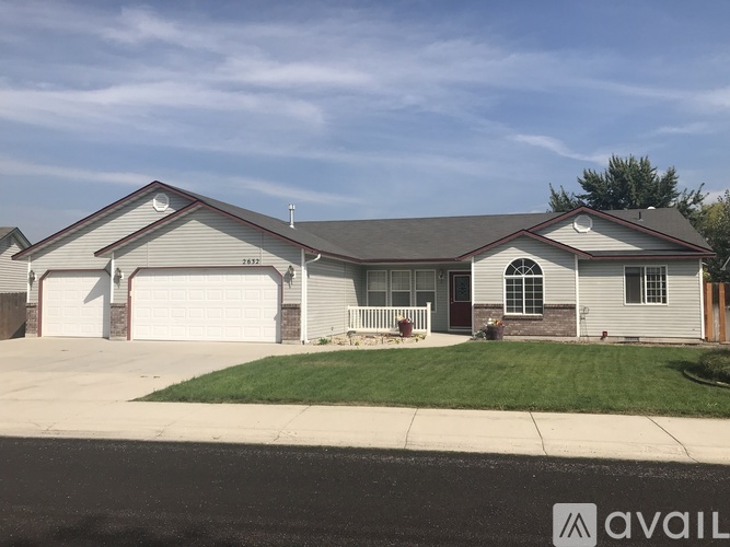 A house with a garage and a driveway in front.