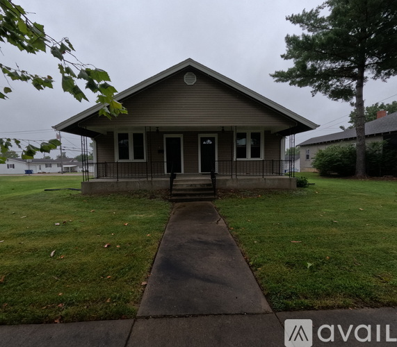 A small house with a front porch is available for rent.