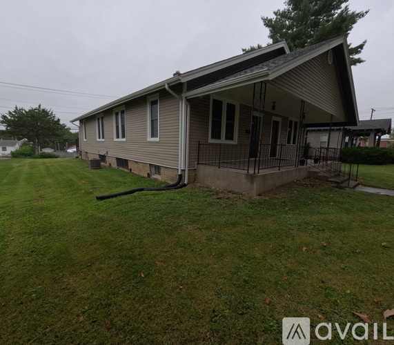 A house with a grey roof and a black fence.