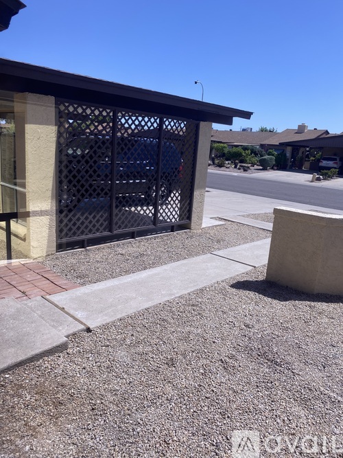 A building with a black gate and a concrete pillar.