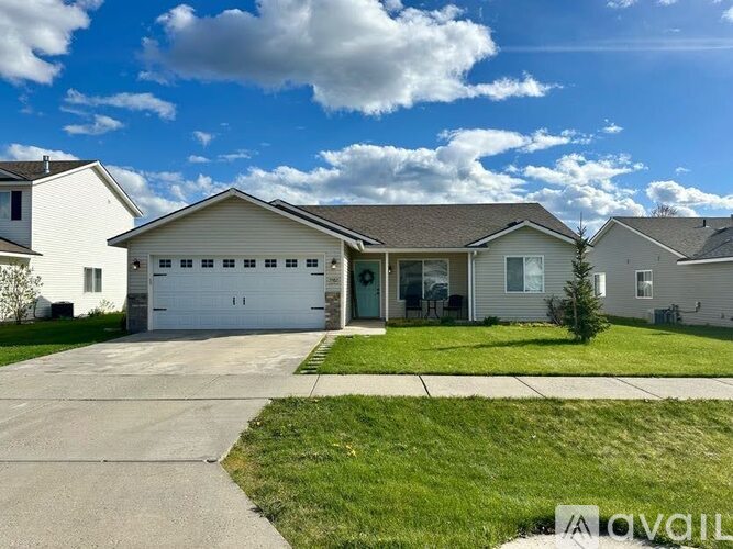 A house with a garage is situated in a residential area.