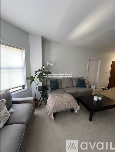 A living room with a grey sofa and a coffee table.