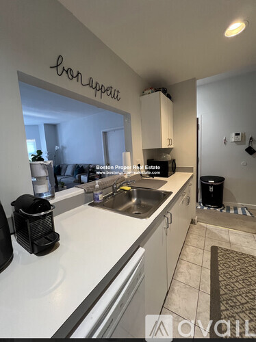 A kitchen with a counter top and a sink.