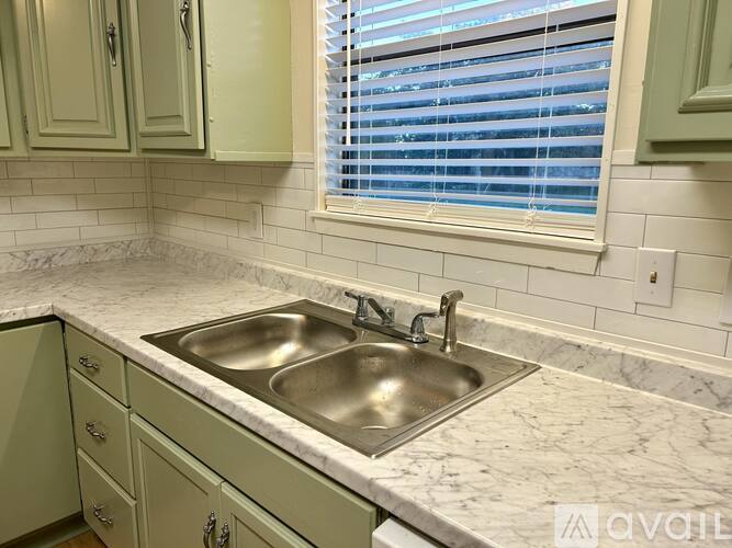 A kitchen with a sink and a window.
