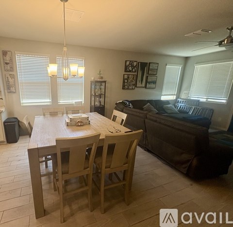 A dining room with a wooden table and chairs.