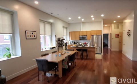 A kitchen with a table and chairs in the middle of the room.