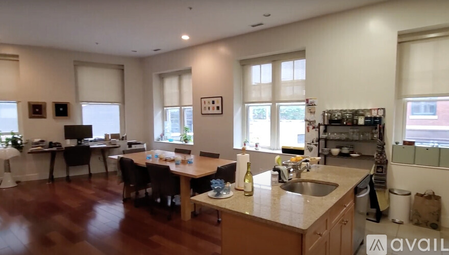 A kitchen with a dining table and chairs is available for rent.