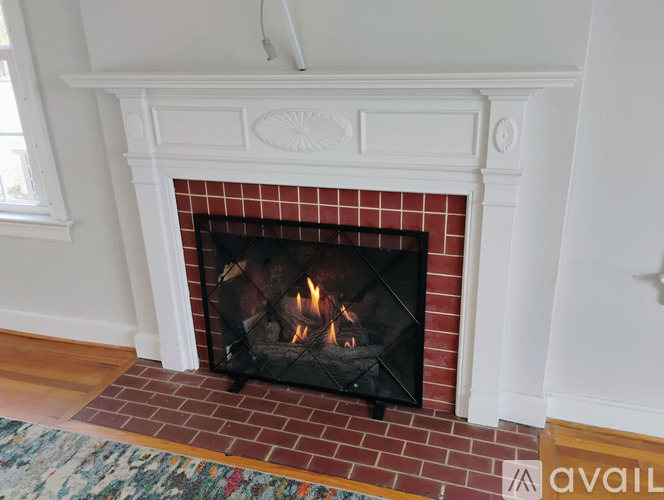 A fireplace with a fire burning inside.