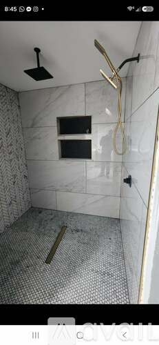 A bathroom with a shower and a tiled floor.